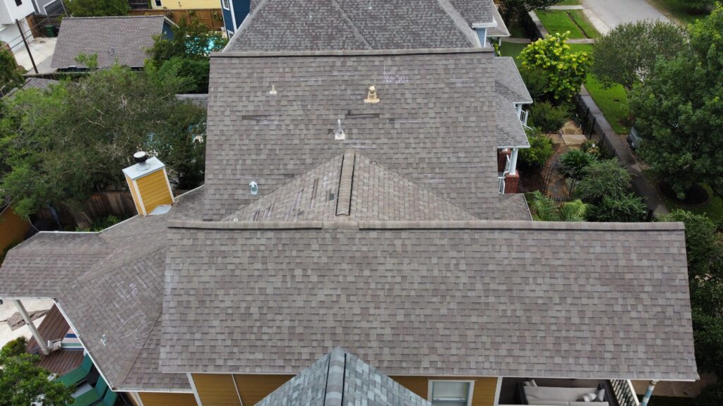 A roof is being inspected to document roof insurance claim